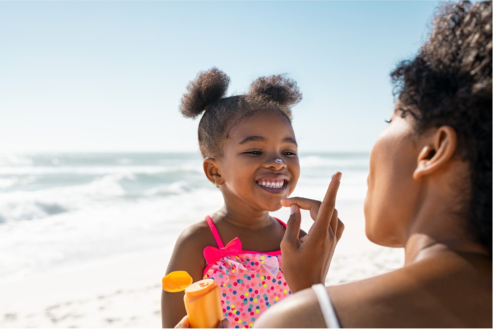 SonderBeaut woman applying sunscreen on daughter